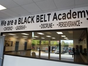"a black belt academy" on wall