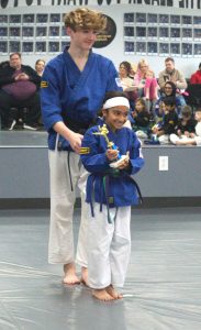 Child receiving an award for completing a goal