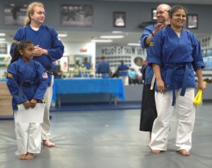 Mother and daughter receiving new belts together