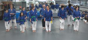 a family of 6 receiving new belts at a promotion ceremony