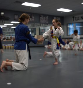 Child breaking a board 