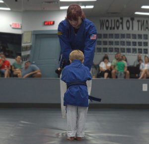 student bowing to receive a new rank