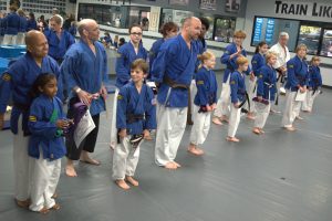 students lined up during fall promotion after receiving new belt 