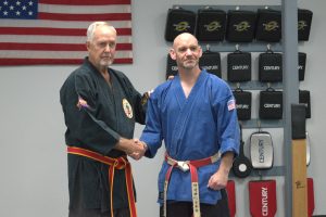 Matthew White shaking hands with O'Sensei Roensch 