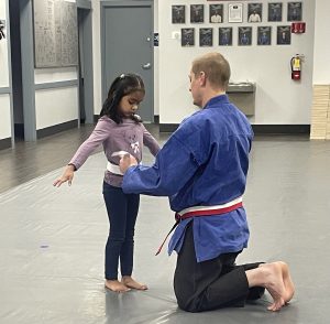 Student earning their White Belt during their first full class 