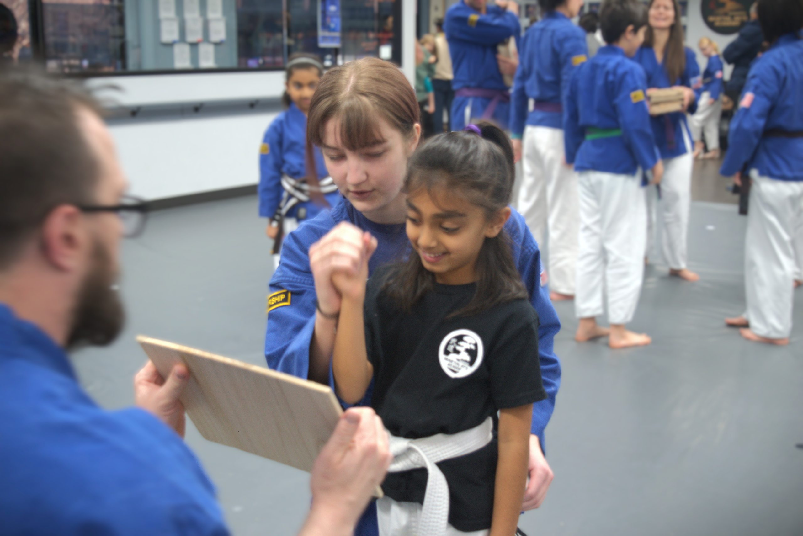 Helping student with board breaking