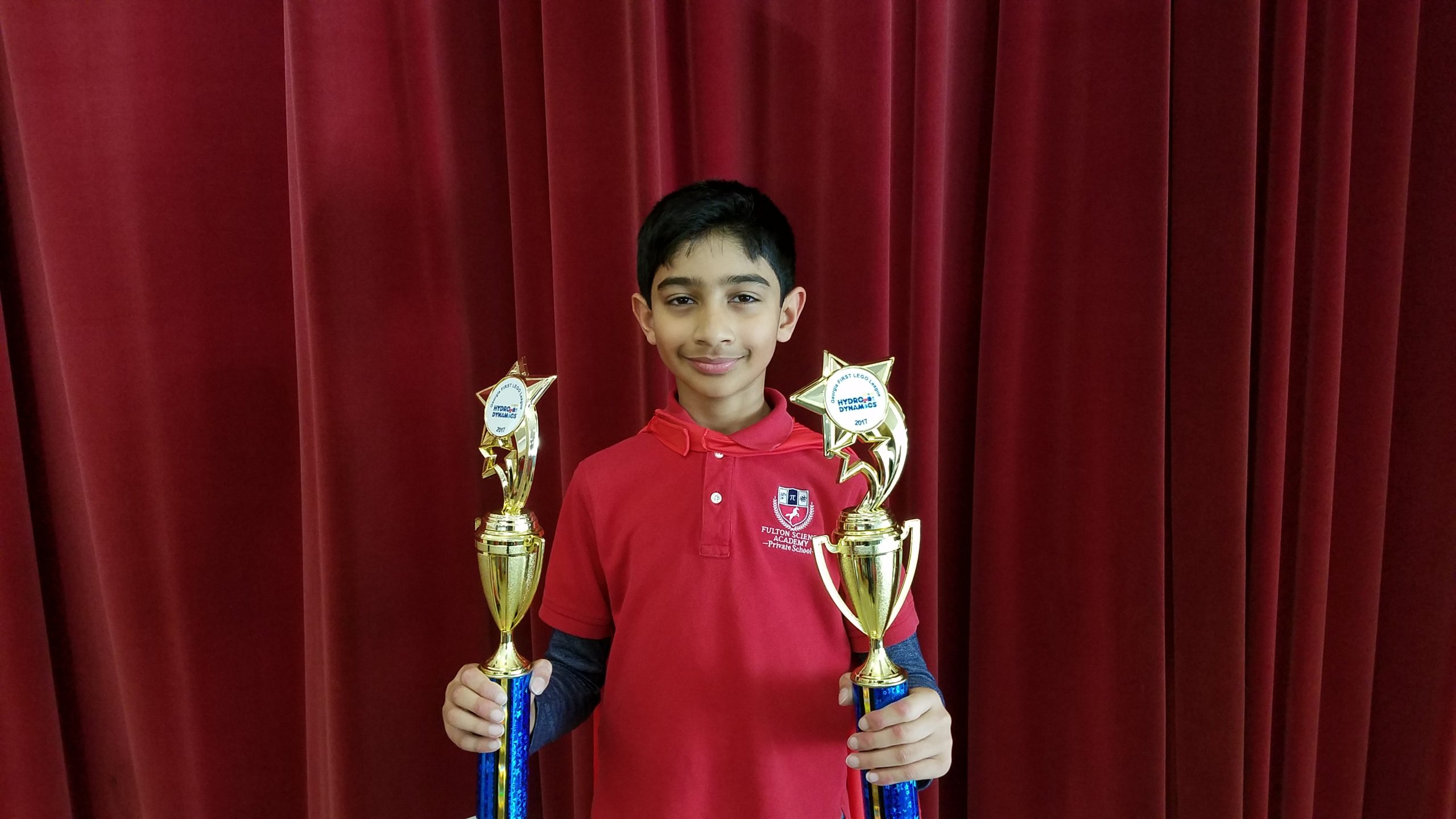 child with karate trophies 