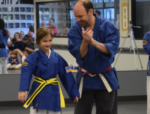 promotion ceremony student receiving new belt
