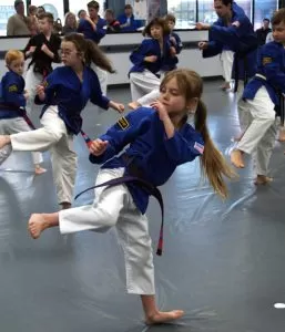 students practicing kicks